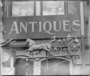 old sign with Antiques in black and white